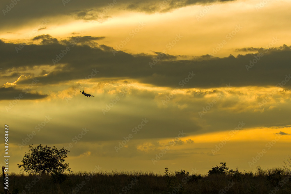 Aeroplane flying into the sunset