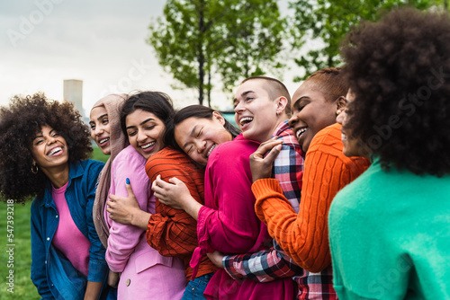 Happy young multi ethnic women having fun together in a public park - Diversity and friendship concept