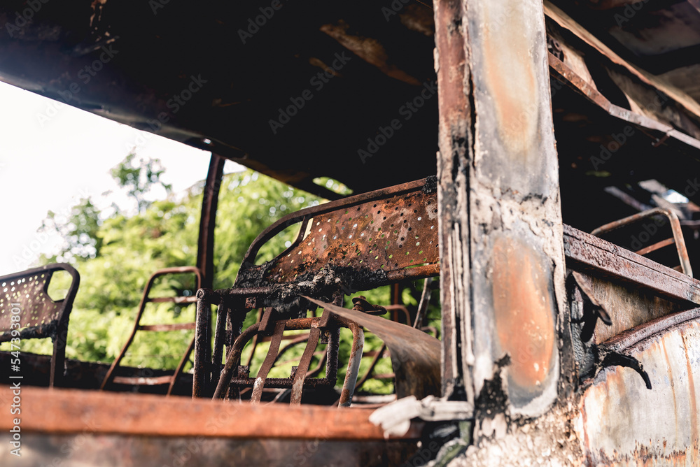 A burnt and totaled bus destroyed by fire abandoned at an empty lot. A burnt and totaled bus destroyed by fire abandoned at an empty lot.