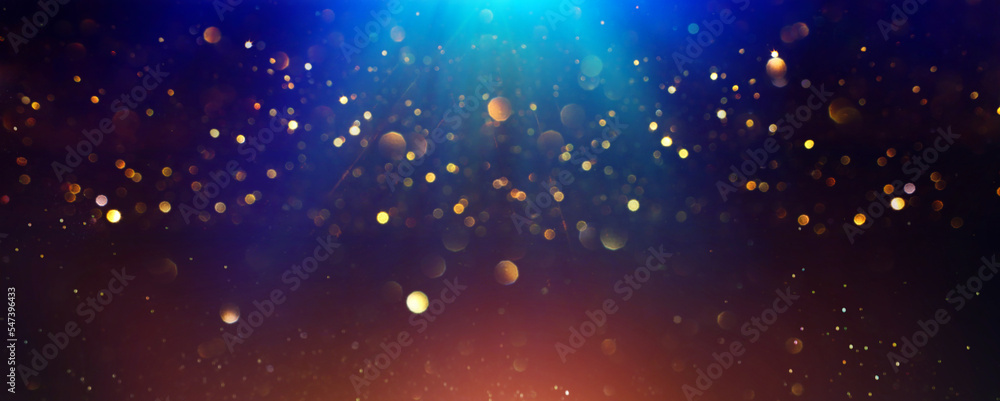Fototapeta premium background of abstract glitter lights. gold, blue and black. de focused