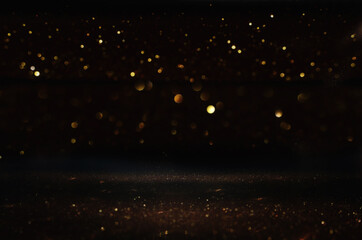 background of abstract glitter lights. gold and black. de focused