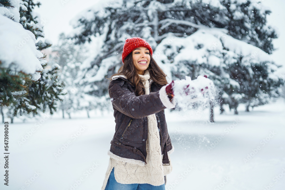 Happy woman enjoying first snow in the forest. Holidays, rest, travel concept Happy woman enjoying first snow in the forest. Holidays, rest, travel concept