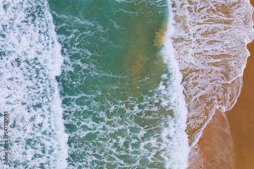 Aerial view of sea crashing waves White foaming waves on beach sand, Top view beach seascape view Nature sea ocean background