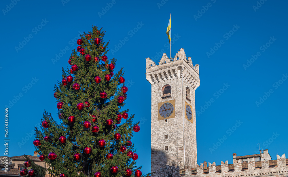 Fototapeta premium Trento Christmas, Cathedral bell tower in piazza del Duomo in Trento with Christmas tree - Trento city, Trentino Alto Adige - northern Italy, november 18, 2022