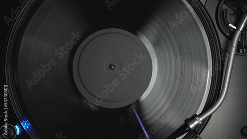 Vertical stock video of DJ record player playing disc with music. Analog turntable device plays hip hop in flat lay footage