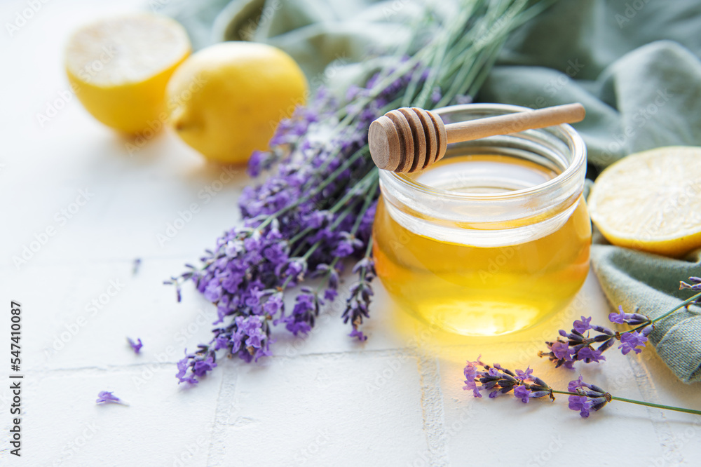 Jar with honey and fresh lavender flowers Jar with honey and fresh lavender flowers