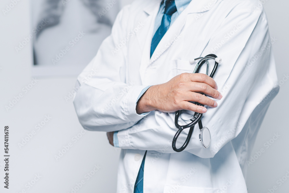 home care, doctor man standing and holding stethoscope in hospital. professional doctor male in clinic hold stethoscope. concept for medical, medicine, health care, diagnostic, listening, measurement home care, doctor man standing and holding stethoscope in hospital. professional doctor male in clinic hold stethoscope. concept for medical, medicine, health care, diagnostic, listening, measurement