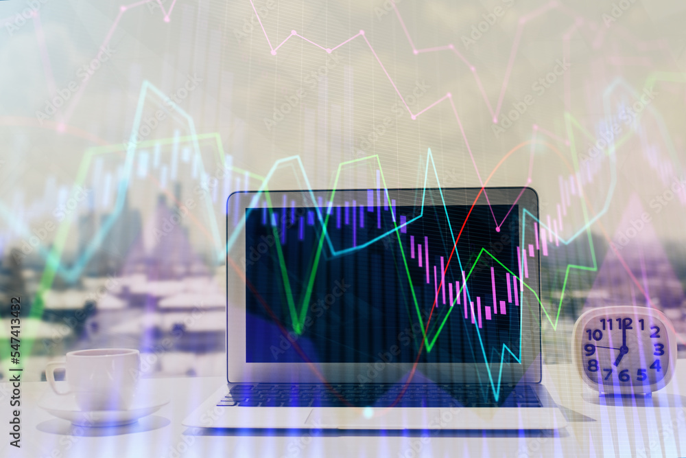Forex graph hologram on table with computer background. Multi exposure. Concept of financial markets.