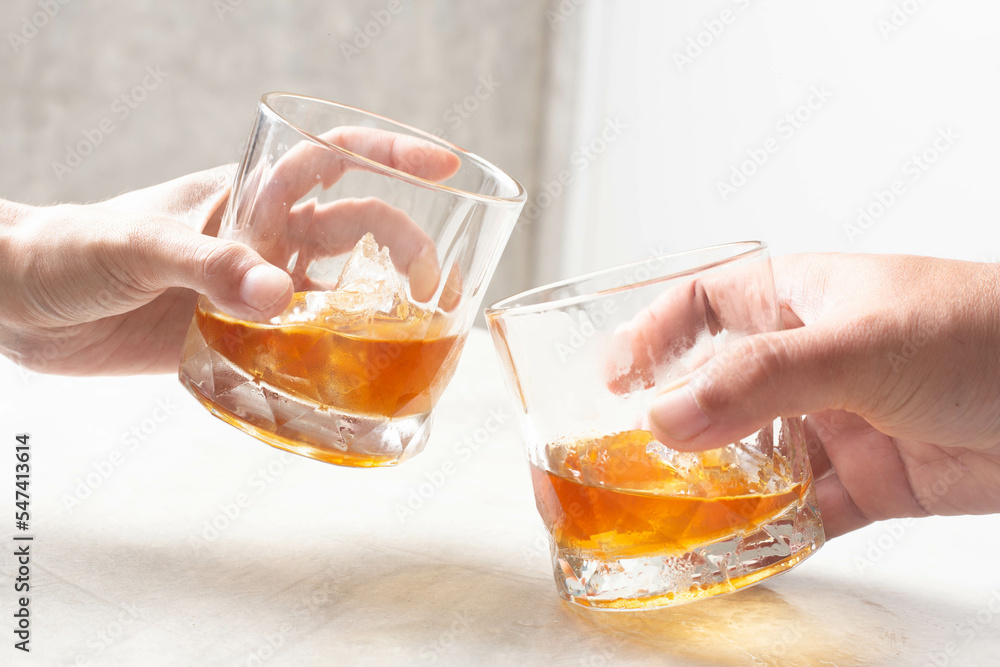 Man and woman clinking whiskey drinking alcohol together at home, young people friendship concept
Man and woman clinking whiskey drinking alcohol together at home, young people friendship concept