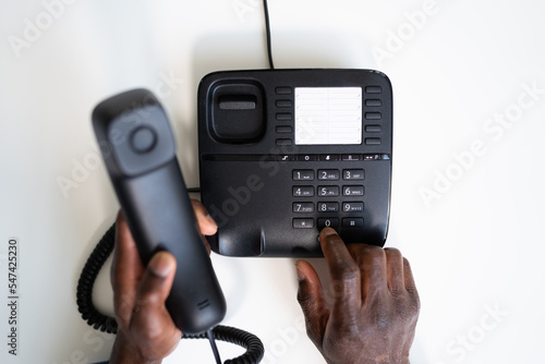 Tablou pe pânză Businessman's Hand Dialing Telephone Number To Make Phone Call