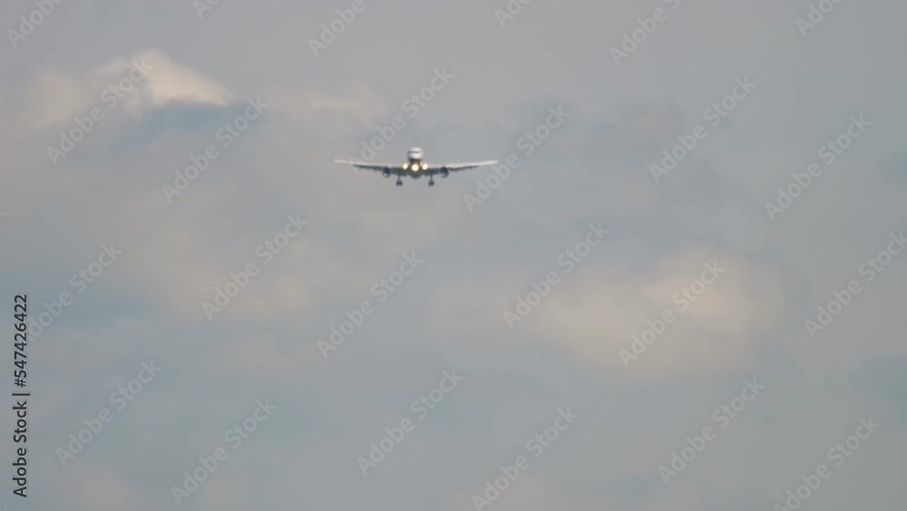 Front view of unrecognizable airplane approaching before landing. Tourism and travel concept Front view of unrecognizable airplane approaching before landing. Tourism and travel concept