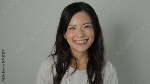 Asian beautiful woman smiles at the camera. Happy, Joy, Delighted. Dolly in. photo