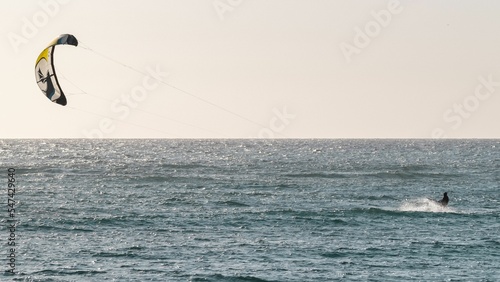 Beautiful shot of a kitesurfer on the water in Sardinia, Italy