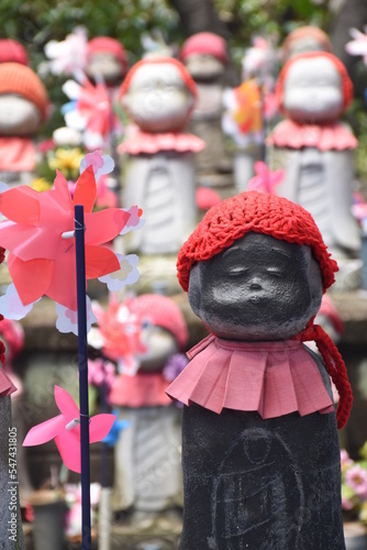 Stone Jizo statues, patrons of unborn children, at Zozo-ji Temple in Tokyo photo