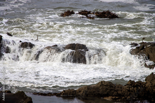 Waves breaking against rocks along the Pacific coast