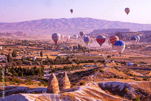 valley of Cappadocia in the early morning with hot air balloons.