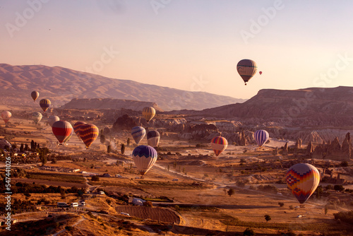 valley of Cappadocia in the early morning with hot air balloons.