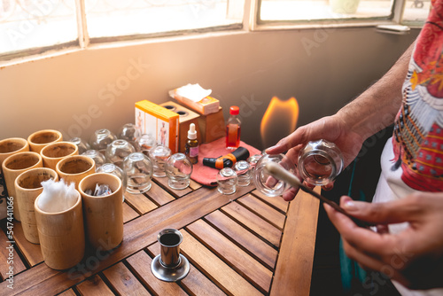 Fotografie Traditional chinese medicine doctor sterilizing tools with alcohol and fire in a