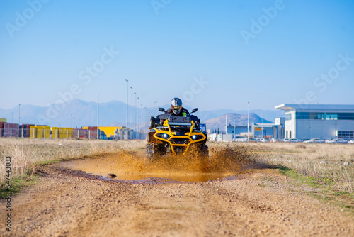 Girl driving ATV on dirt road