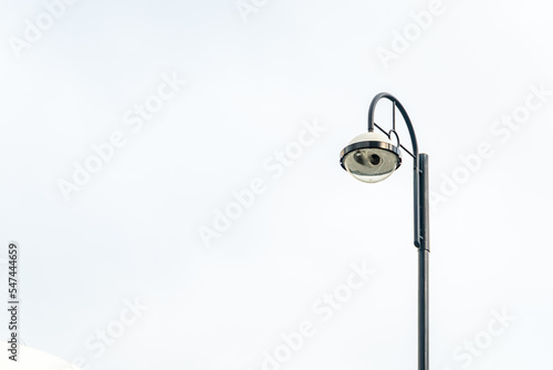Light post with white sky background and multi light, copy space © CHOKCHAI