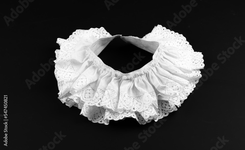 Fényképezés vintage white collar with ruffles on black background