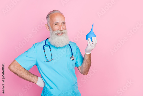Billede på lærred Photo of experienced doctor assistant hold blue enema examine patient in hospita