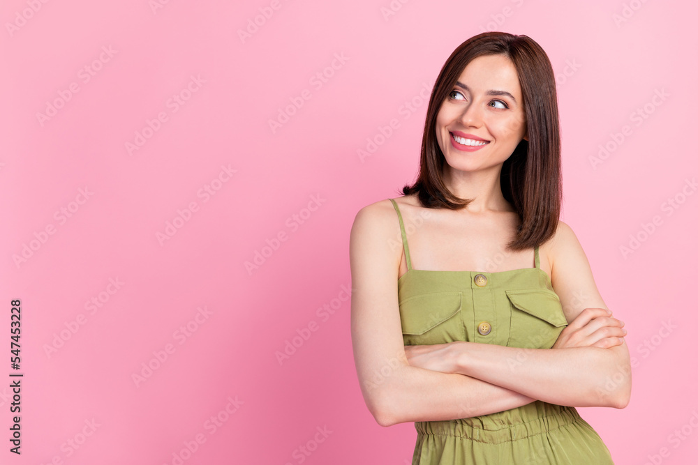 Photo of positive confident gorgeous girl bob hairdo dressed khaki overall arms folded look empty space isolated on pink color background Photo of positive confident gorgeous girl bob hairdo dressed khaki overall arms folded look empty space isolated on pink color background
