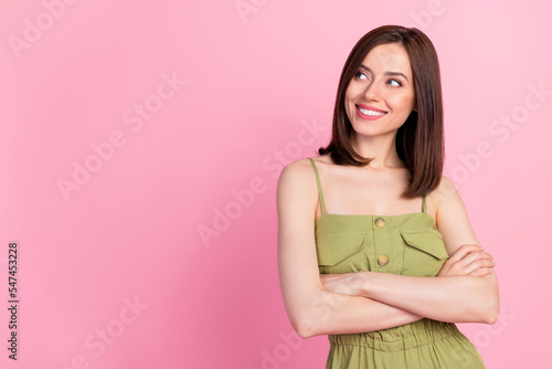 Photo of positive confident gorgeous girl bob hairdo dressed khaki overall arms folded look empty space isolated on pink color background