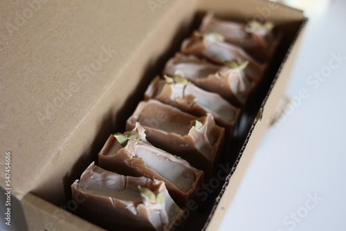 Handmade cold process brown soap in a cardboard box photo