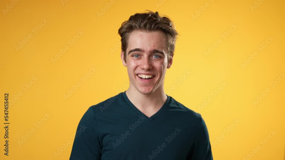 Portrait of smiling happy young hipster man 20s isolated on solid yellow background with copy space in studio Portrait of smiling happy young hipster man 20s isolated on solid yellow background with copy space in studio