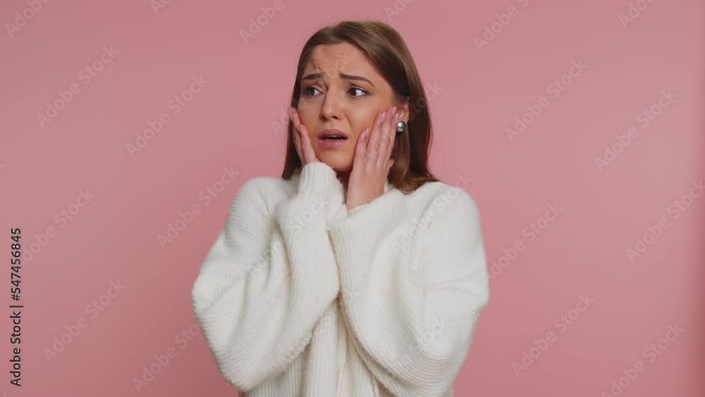Upset scared frightened young woman biting nails, feeling worried nervous about serious troubles, stress and anxiety disorder, panic attack guilty. Caucasian girl isolated on studio pink background Upset scared frightened young woman biting nails, feeling worried nervous about serious troubles, stress and anxiety disorder, panic attack guilty. Caucasian girl isolated on studio pink background