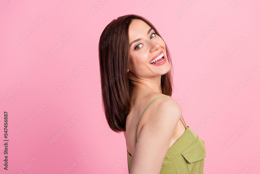 Side profile photo of gorgeous optimistic nice woman with bob hairdo dressed khaki overall smiling isolated on pink color background Side profile photo of gorgeous optimistic nice woman with bob hairdo dressed khaki overall smiling isolated on pink color background