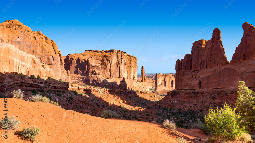 Sunny Picturesque Desert Rock Valley, Natural Monument Avenue Viewpoint and Courthouse Towers at Arches National Park, Utah, USA