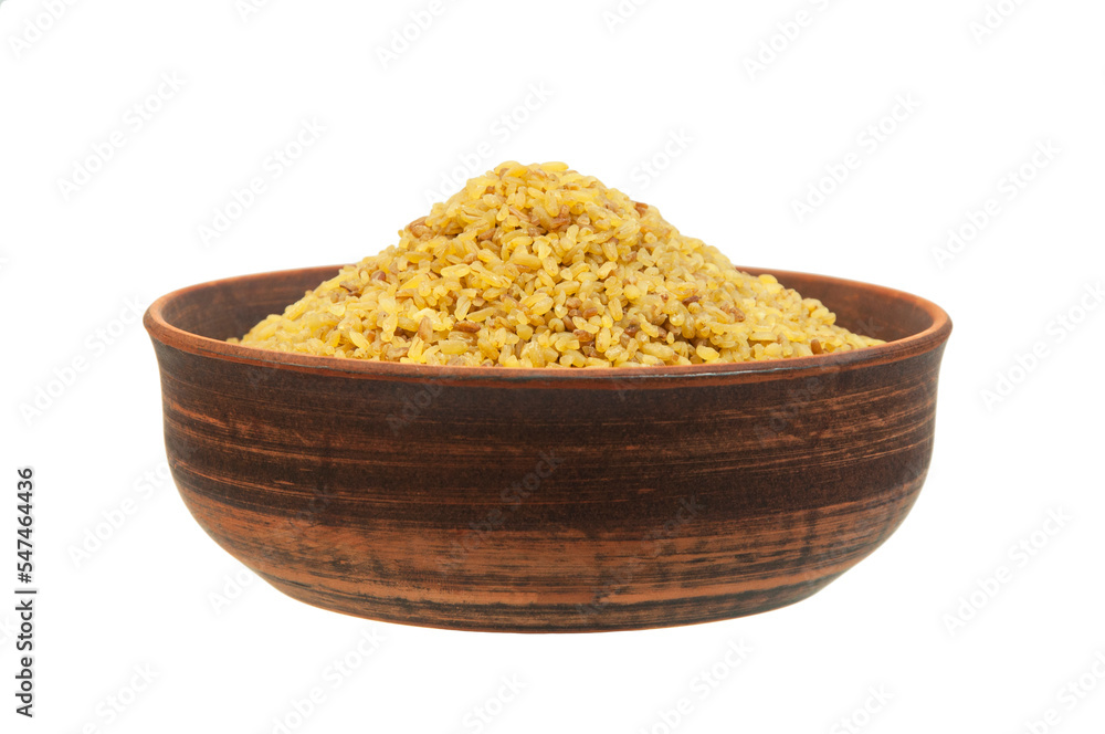 bulgur in a clay bowl on a white background. the concept of a good harvest of bulgur bulgur in a clay bowl on a white background. the concept of a good harvest of bulgur