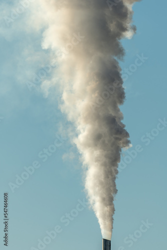 Column of smoke coming out of an industrial chimney.