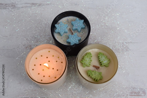 Holiday soy candles with snowflake, tree molds and gold stars. 