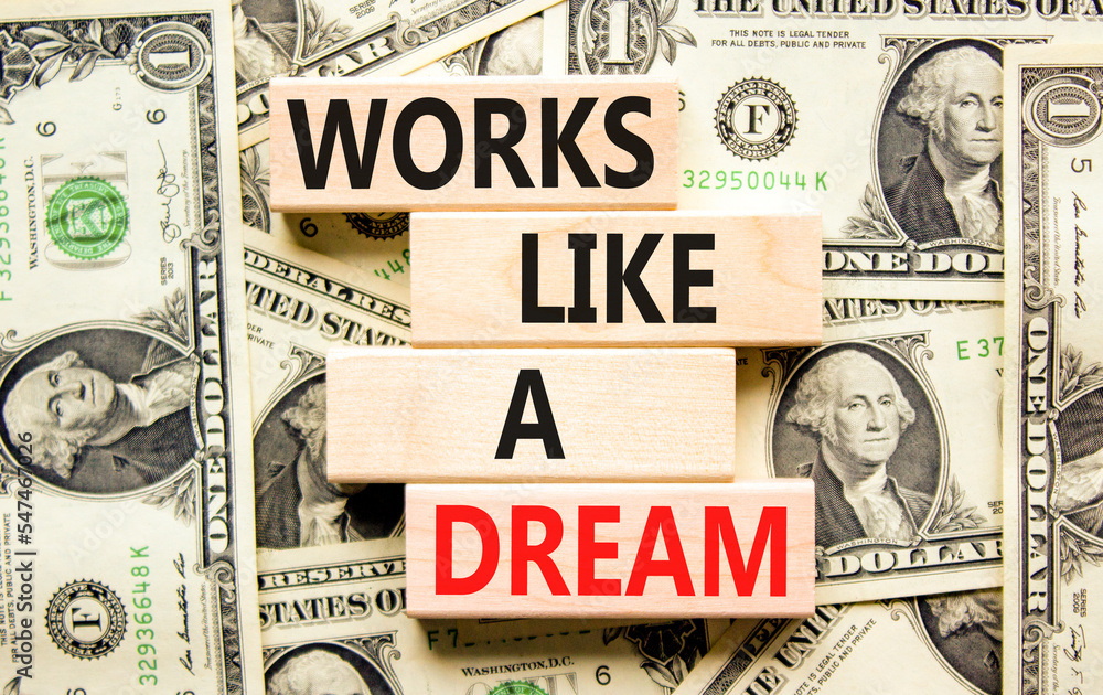 Works like a dream symbol. Concept words Works like a dream on wooden cubes. Beautiful background from dollar bills. Business motivational works like a dream concept. Copy space.