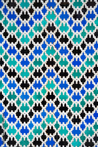 Geometric seamless andalusian moroccan islamic arabic zigzag pattern in blue made out of ceramic tiles in Spain Sevilla horizontally 