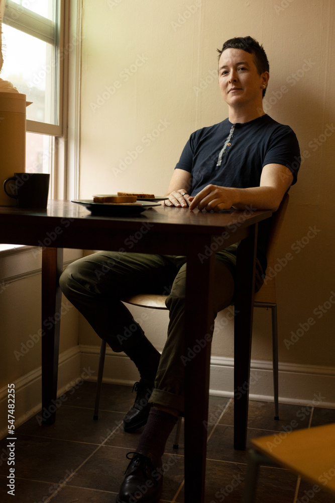 Fototapeta premium Portrait of nonbinary person by window
