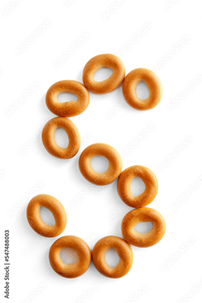 Letter S bagel. Bagels font. Alphabet from set of small dry bagels isolated on white background. ABC symbols.