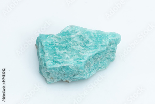 Natural amazonite gemstone isolated on white background. A bluish-green crystal on a white background. A variety of potassium feldspar microcline photo