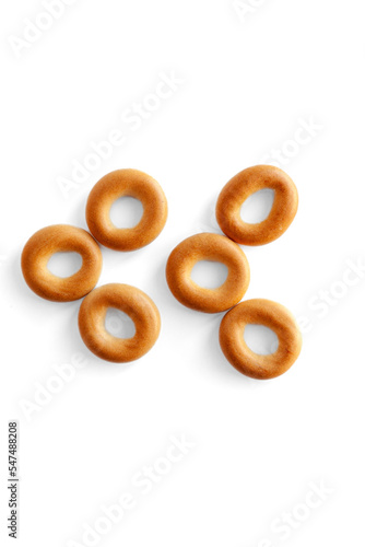 Symbol quote bagel. Bagels font. Alphabet from set of small dry bagels isolated on white background. ABC symbols.