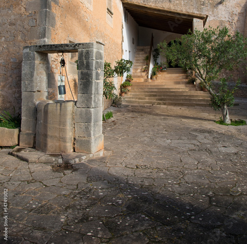 Old well in the courtyard of an old church in Mallorca