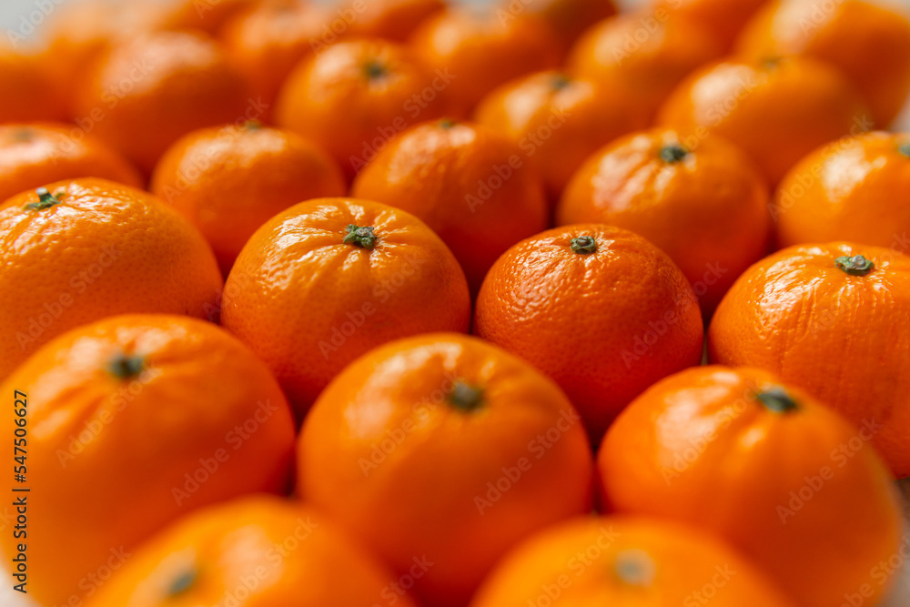 Basket with tangerine or orange fruit on a gray plaid background. Basket with tangerine or orange fruit on a gray plaid background.
