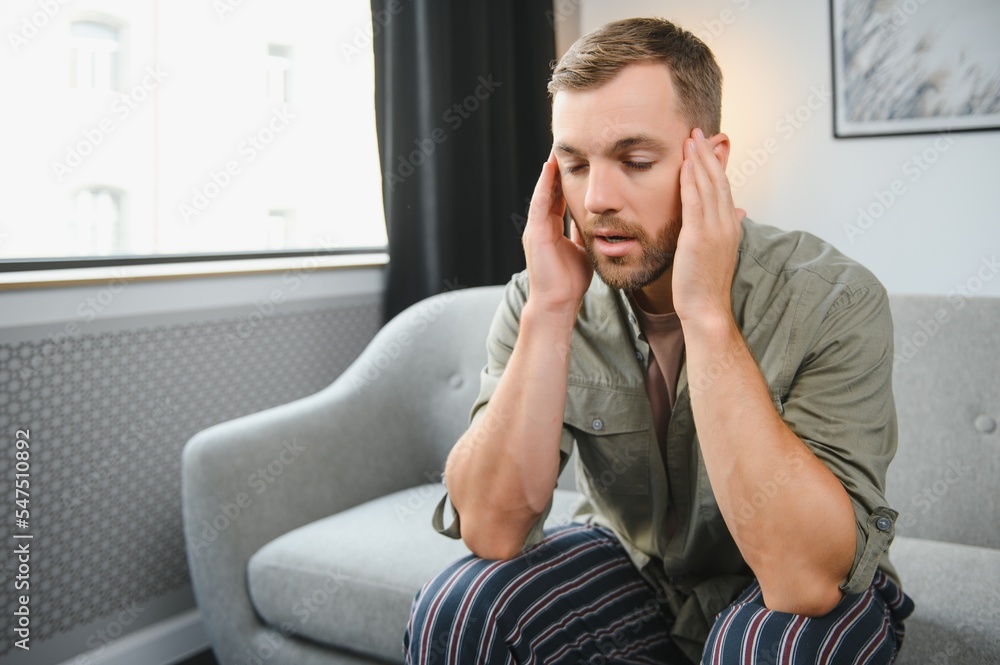 Man having a headache at home Man having a headache at home
