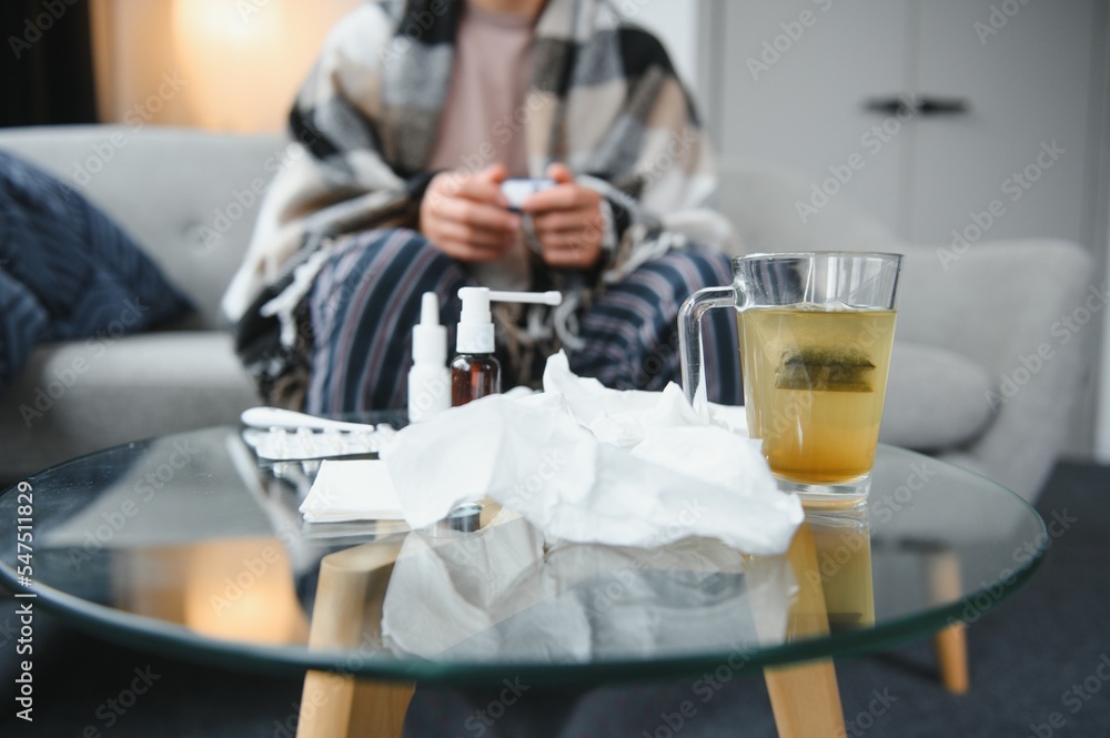 Close-up man's hands holds white plastic bottle with pills and ready to take supplement pill with glass of water. Ill man taking medication. Sick person need medicine against a headache and cold Close-up man's hands holds white plastic bottle with pills and ready to take supplement pill with glass of water. Ill man taking medication. Sick person need medicine against a headache and cold