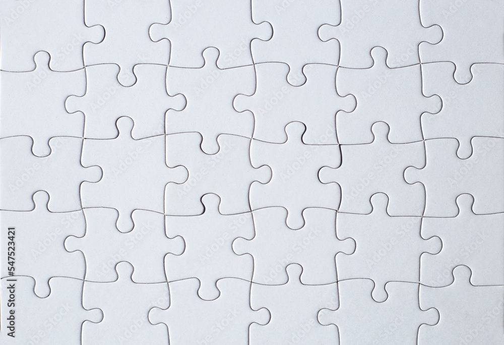 Full-frame photograph of a white jigsaw puzzle Full-frame photograph of a white jigsaw puzzle