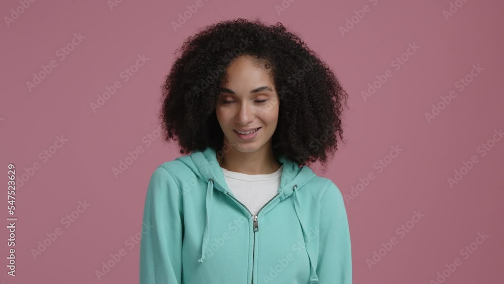 Mixed race woman looks seductive and happy while posing in empty room. Close-up shot of a girl in her 30s smiling cheerfully. High quality 4k footage Mixed race woman looks seductive and happy while posing in empty room. Close-up shot of a girl in her 30s smiling cheerfully. High quality 4k footage