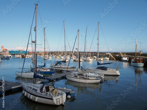 boats and yachts moored in marina section of scarborough harbour in summer sunlight