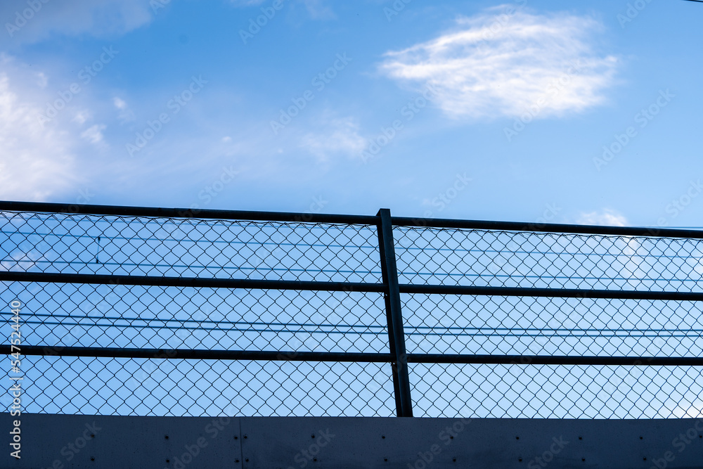 blue beautiful bright sky with a metal railing visible below it blue beautiful bright sky with a metal railing visible below it